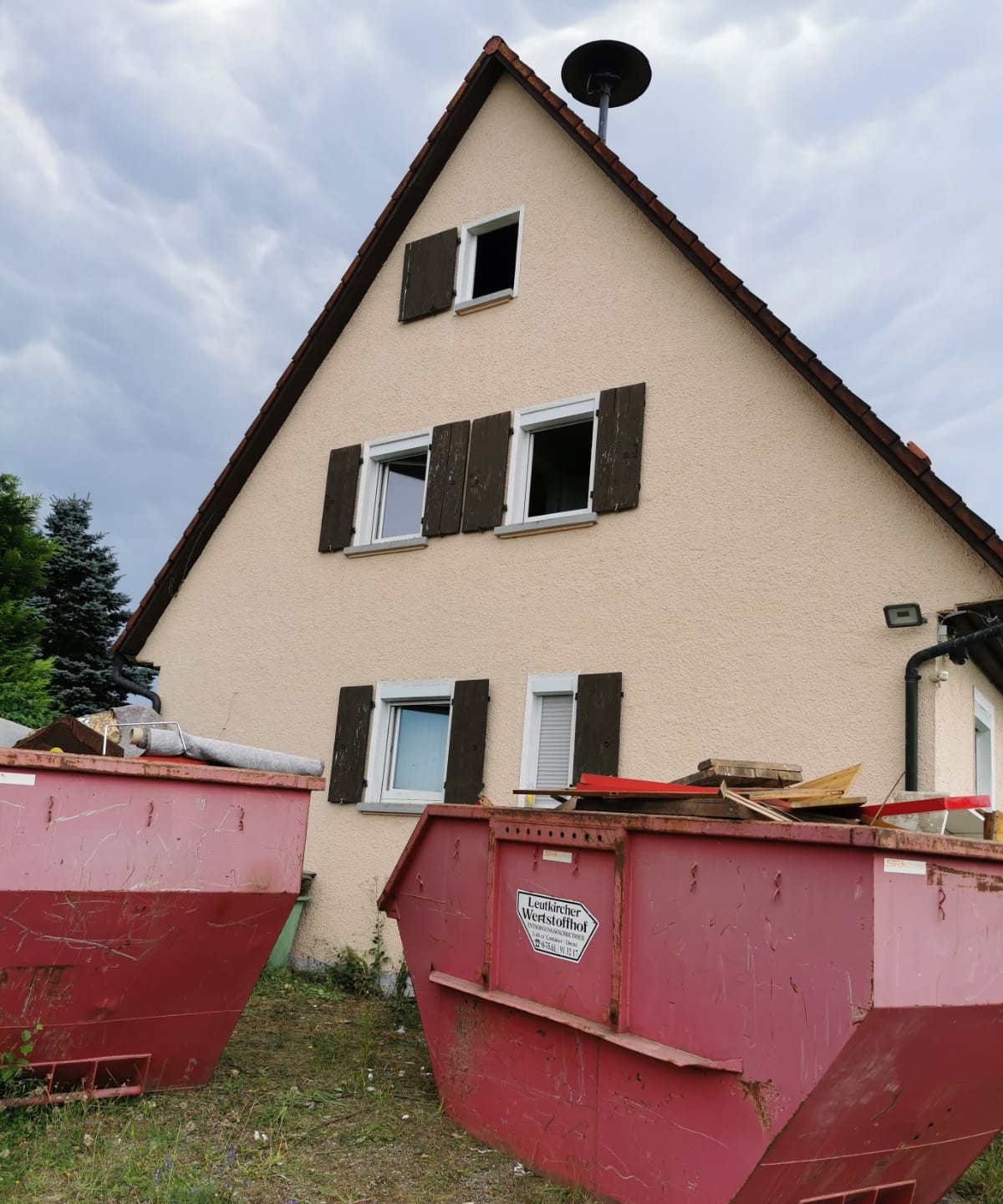 Entsorgungscontainer vor einem Einfamilienhaus bei einer Haushaltsauflösung im Allgäu